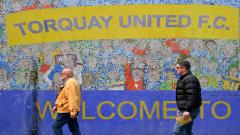 Torquay United fans make their way to a match